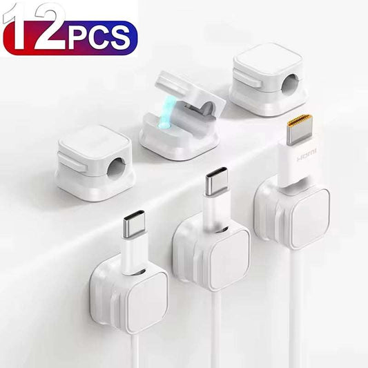 Magnetic cable clip holding charging cables with adhesive base for desk organization