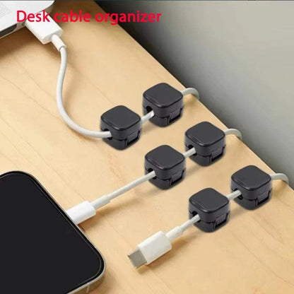 Magnetic cable clip holder organizing cords on desk with adhesive base