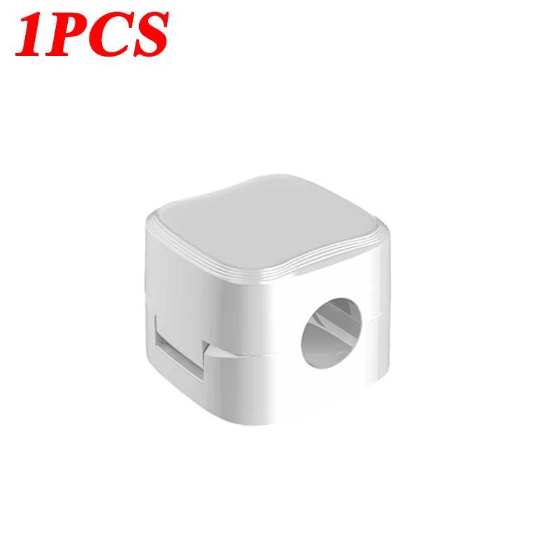 Magnetic cable clip holding multiple cords on desk for cable organization and management